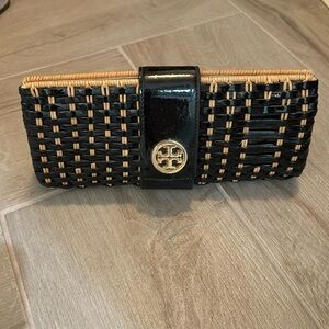 Tory Burch wicker and patent leather clutch handbag.